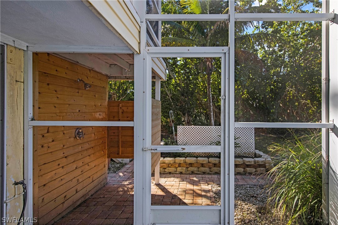 705 Rabbit Road Sanibel, FL 33957 - Photo 31 of 35 a view of a glass door with a from a window