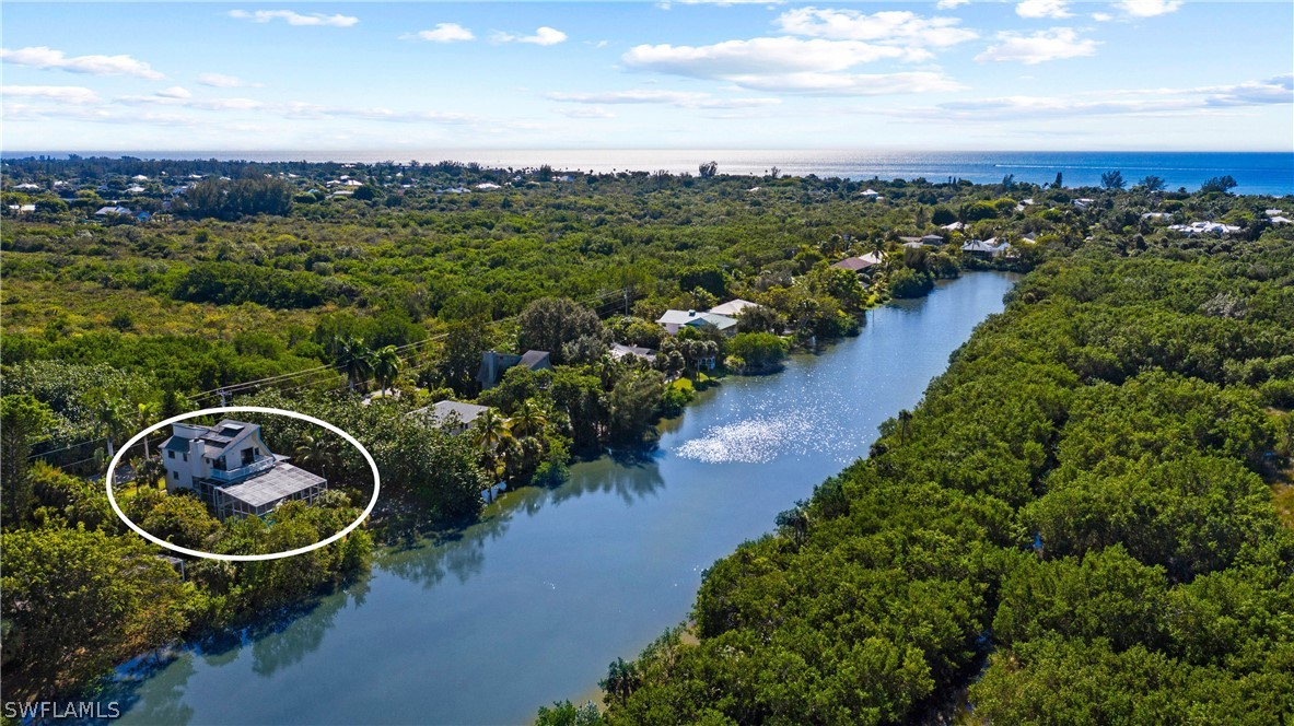 705 Rabbit Road Sanibel, FL 33957 - Photo 35 of 35 an aerial view of a house with outdoor space and lake view in back