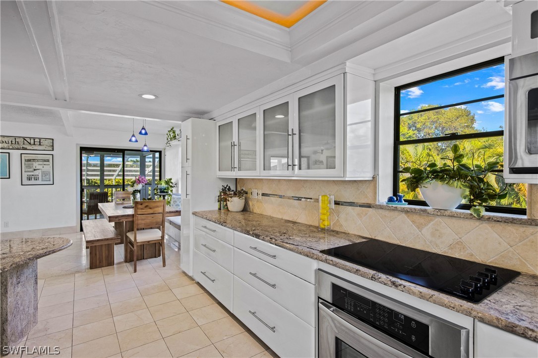 705 Rabbit Road Sanibel, FL 33957 - Photo 5 of 35 a kitchen that has a sink and chair in it