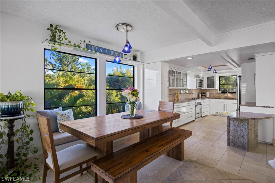 705 Rabbit Road Sanibel, FL 33957 - Photo 7 of 35 a view of a dining room with furniture window and wooden floor