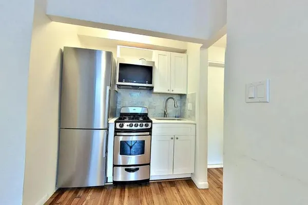 a kitchen with stainless steel appliances a refrigerator and a stove