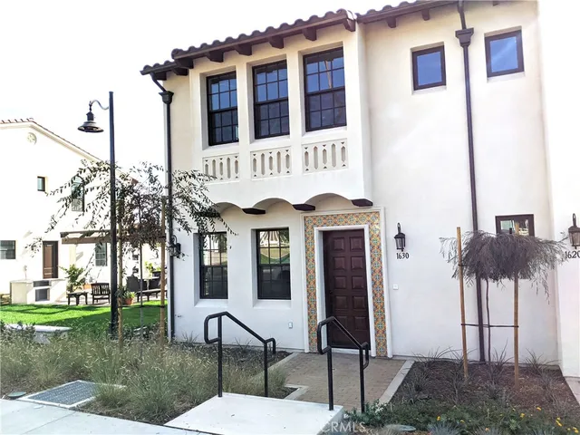 a view of a building with a bench and plants