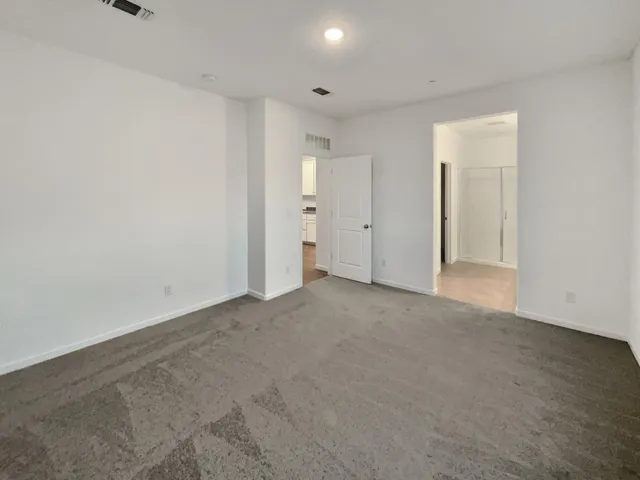 a view of kitchen with kitchen island granite countertop a stove top oven and a sink with granite countertops