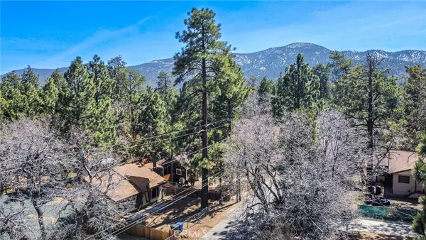 a view of a house with a yard and mountain
