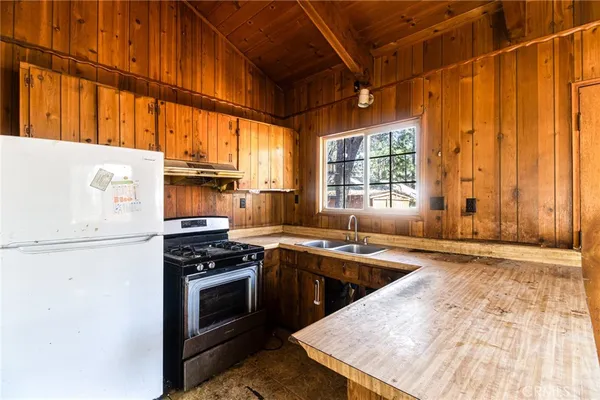 a kitchen with a stove a sink and a microwave