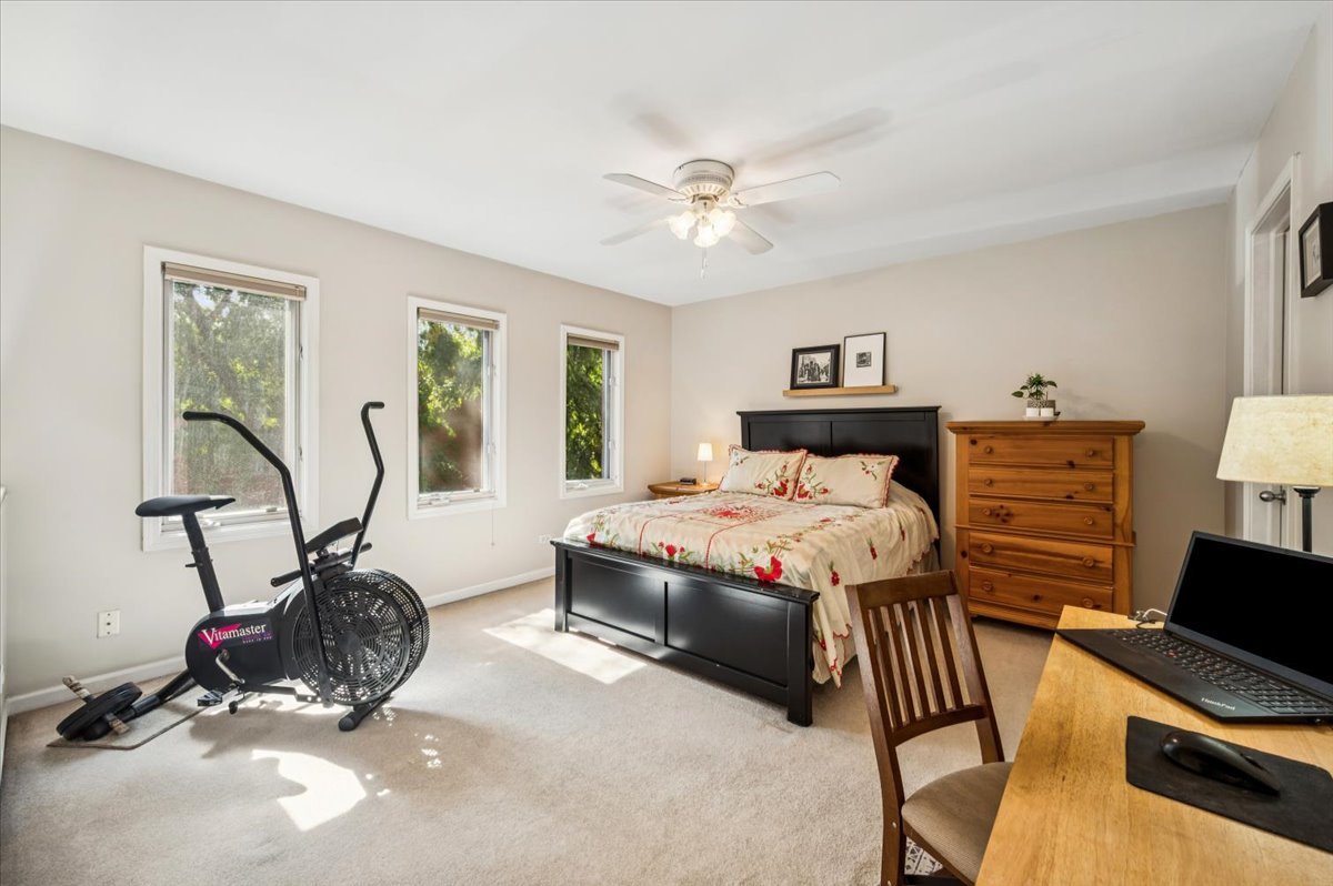 1200 South Federal Street, Unit D Chicago, IL 60605 - Photo 14 of 20 a bedroom with a bed a couch and a chandelier