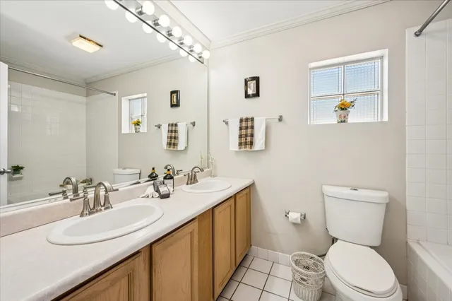 a bathroom with a toilet a sink a mirror and vanity
