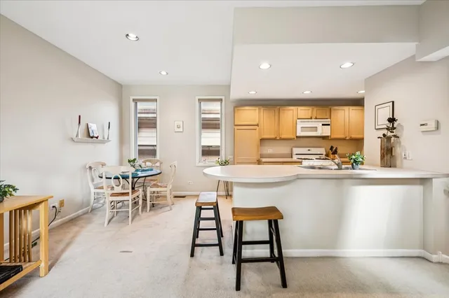a kitchen with counter space dining table and chairs