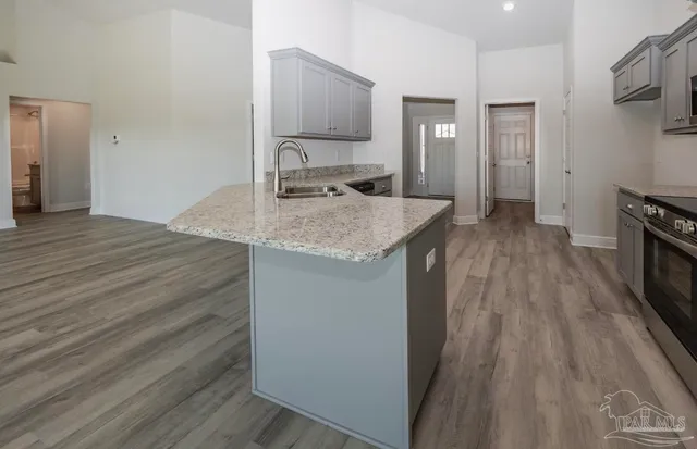 a kitchen with a sink and a refrigerator