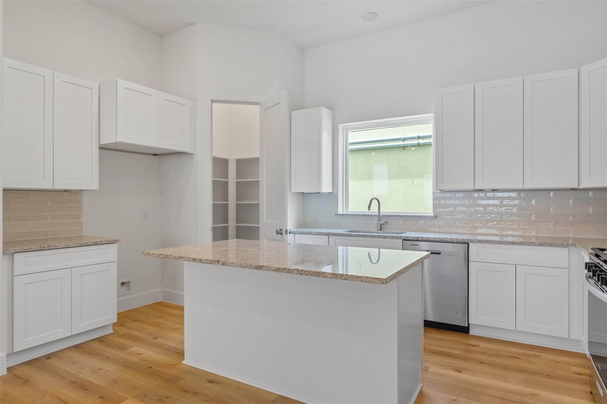 1928 Purswell Road Houston, TX 77055 - Photo 11 of 36 This stylish open kitchen boasts quartz countertops, chrome appliances, and a seamless flow into the main living spaces—perfect for entertaining.