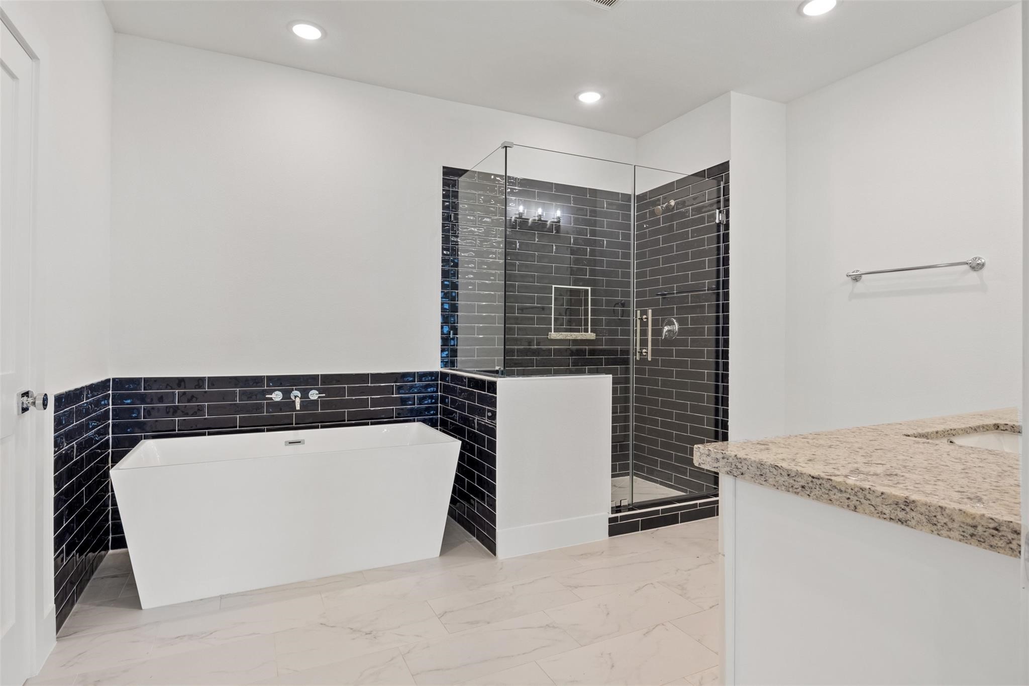 1928 Purswell Road Houston, TX 77055 - Photo 19 of 36 A bold yet balanced primary bath where masculine meets feminine—dual-tone finishes, and elevated design create a spa-like retreat that’s as stylish as it is serene.