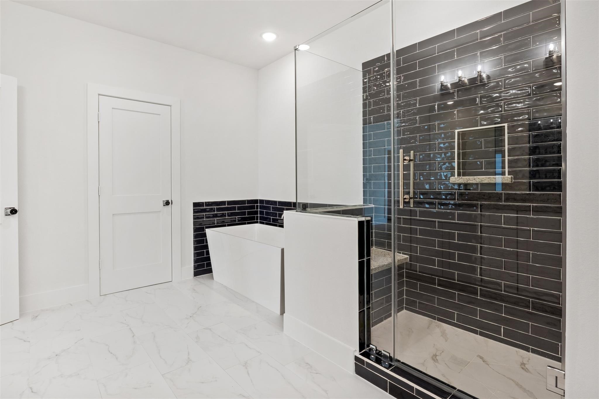 1928 Purswell Road Houston, TX 77055 - Photo 20 of 36 Step into your spacious walk-in shower with a comfortable seat or indulge in a relaxing bubble bath. In this retreat, the possibilities are endless!