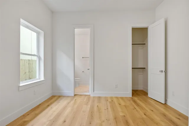 an empty room with windows and closet