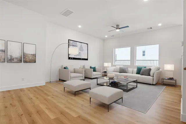 a living room with furniture and white walls