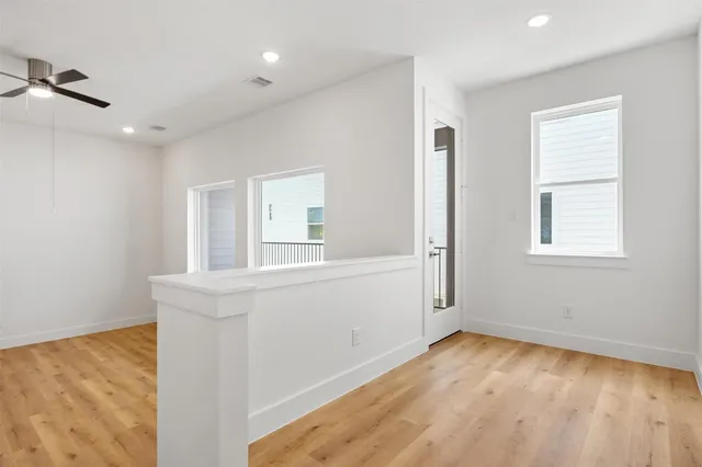 a view of a kitchen with wooden floor and a window