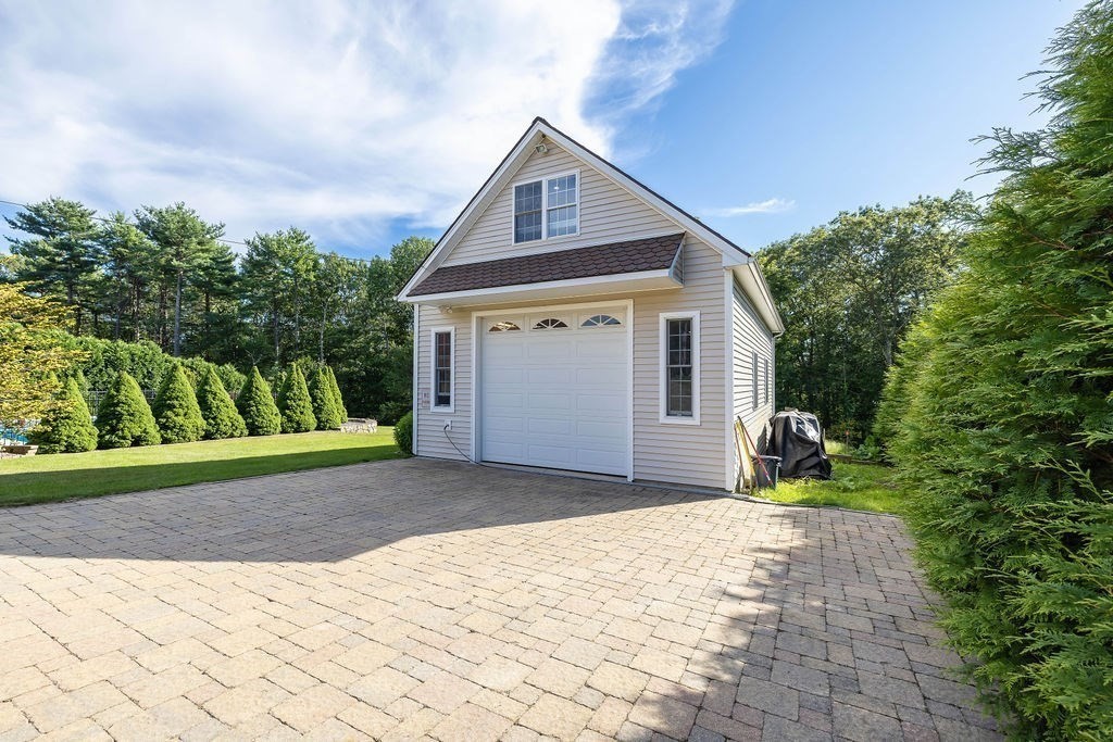 114 Upper Gore Road Webster, MA 01570 - Photo 30 of 40 a front view of a house with a yard and garage
