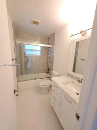 a bathroom with a double vanity sink and mirror