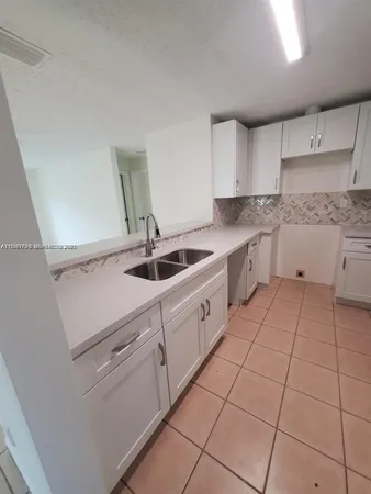 a kitchen with cabinets and white appliances