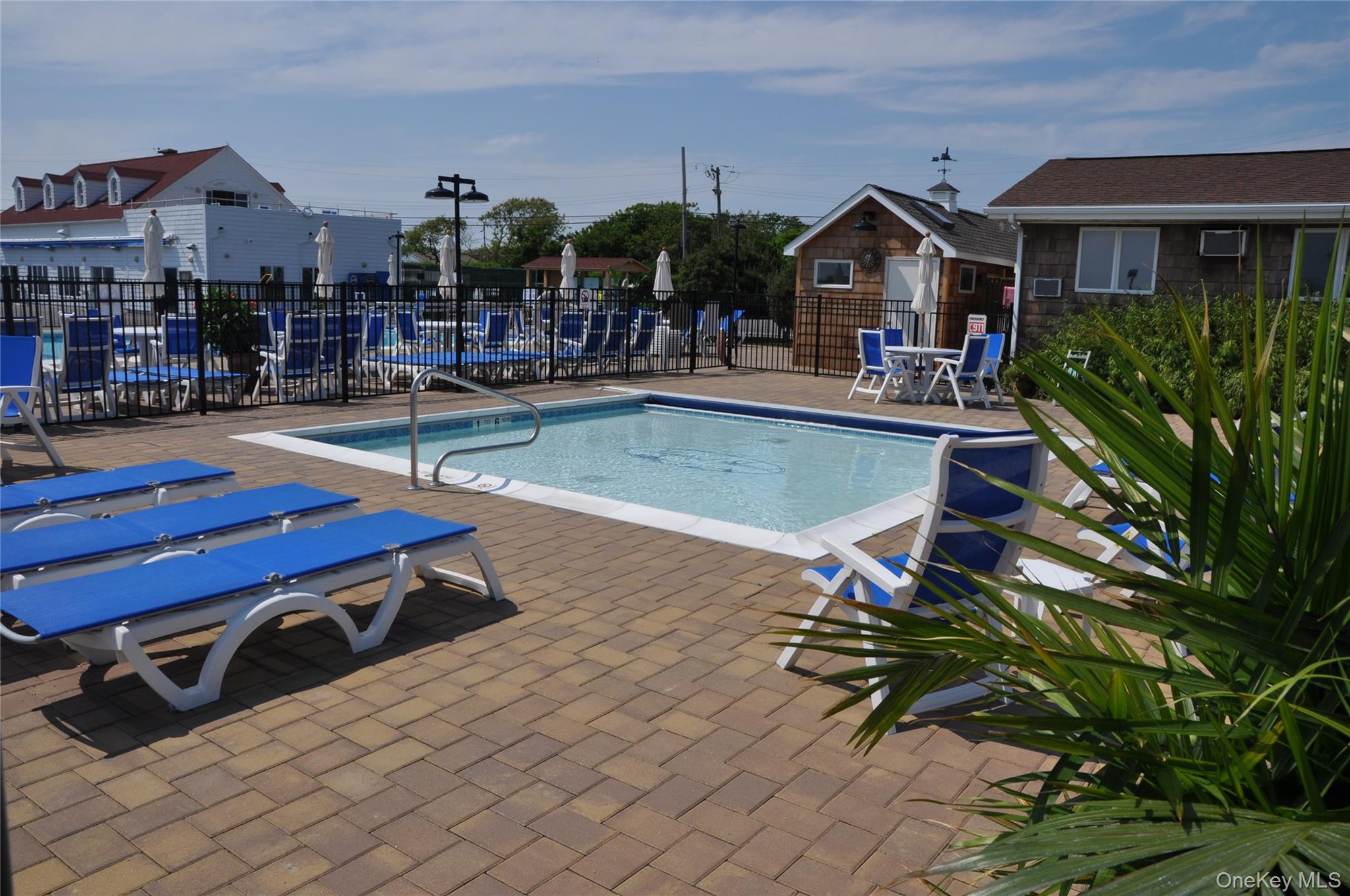 100 Deforest Road, Unit 433 Montauk, NY 11954 - Photo 18 of 26 a swimming pool with outdoor seating and yard