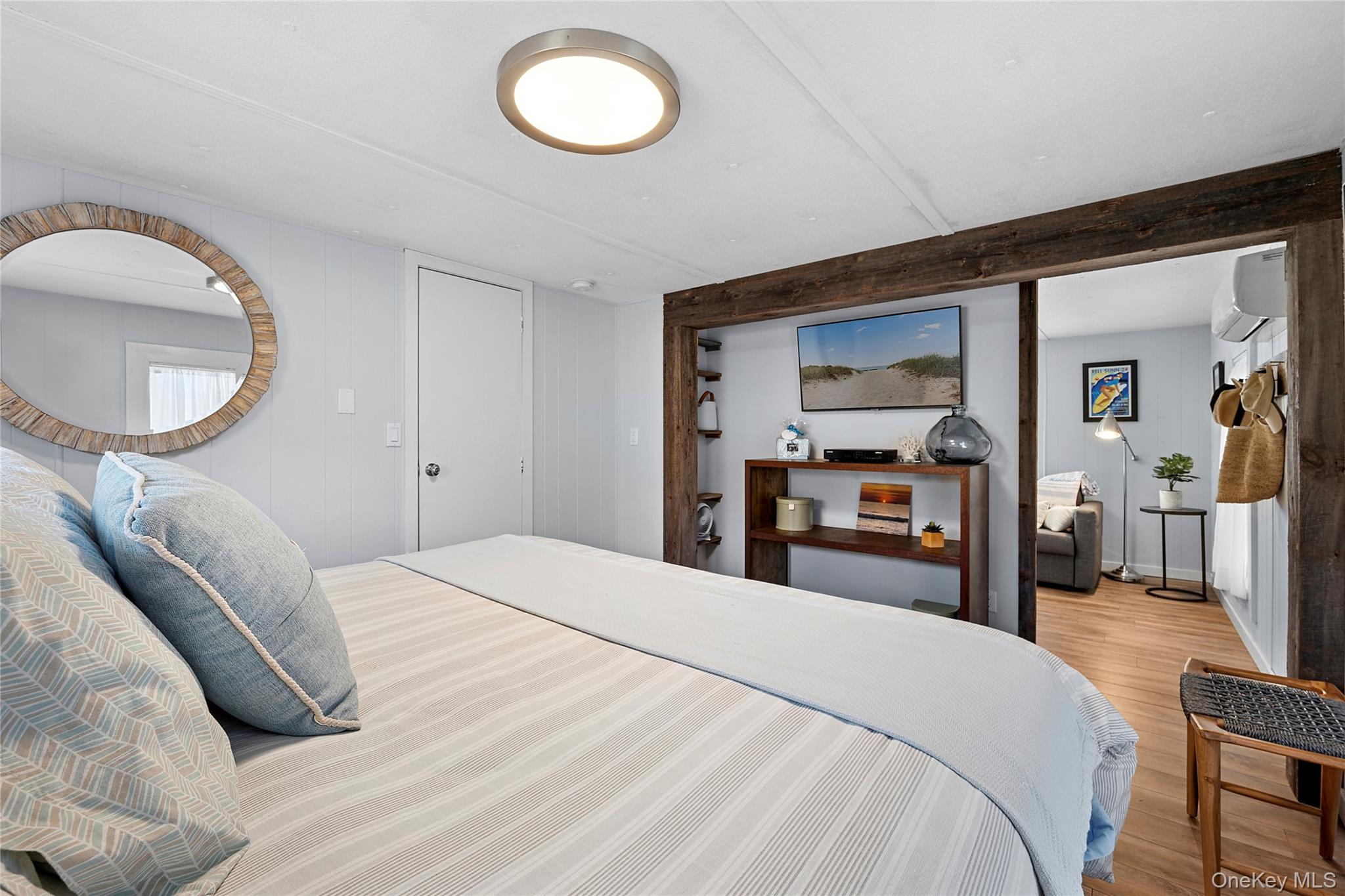 100 Deforest Road, Unit 433 Montauk, NY 11954 - Photo 5 of 26 a bedroom with a bed and a mirror