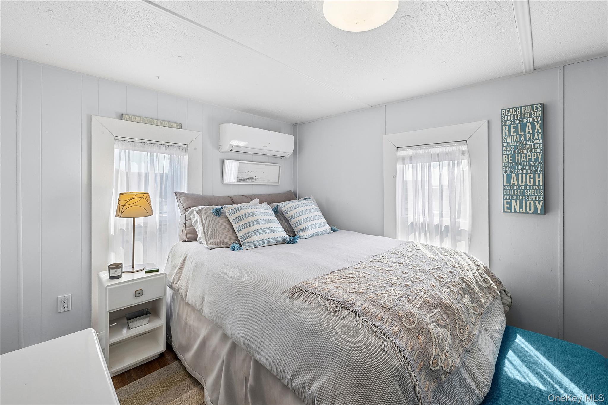 100 Deforest Road, Unit 433 Montauk, NY 11954 - Photo 6 of 26 a bedroom with a bed and wooden floor