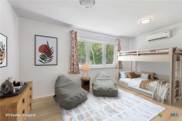 a bedroom with furniture and a window