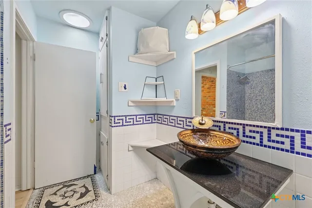 a bathroom with a sink a mirror and a bathtub