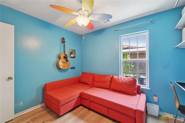 a bed room with a bed and a chair