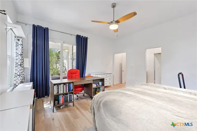 a bedroom with a bed dresser and a window