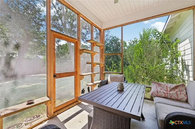 a view of a house with backyard sitting area and garden