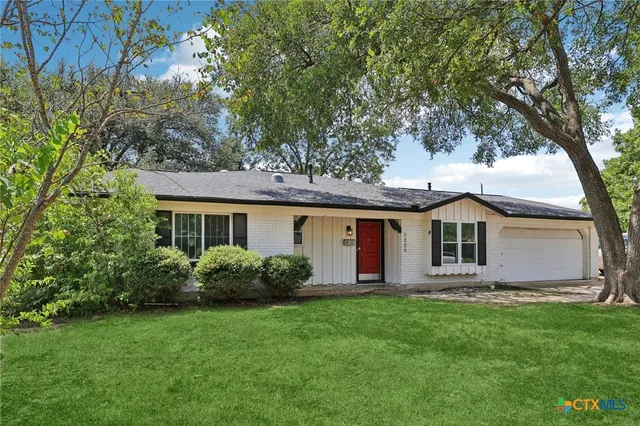 a front view of house with yard and green space