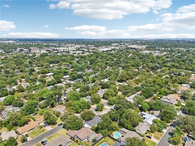 an aerial view of residential building with green space