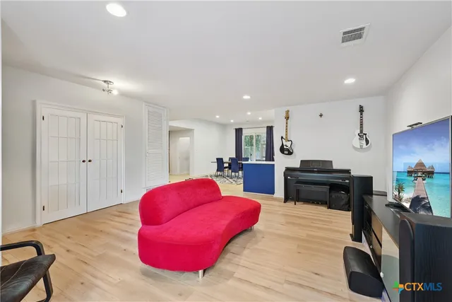 a kitchen with stainless steel appliances kitchen island granite countertop furniture and wooden floor