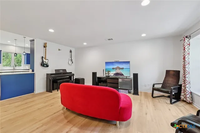 a kitchen with stainless steel appliances kitchen island granite countertop a stove and a refrigerator