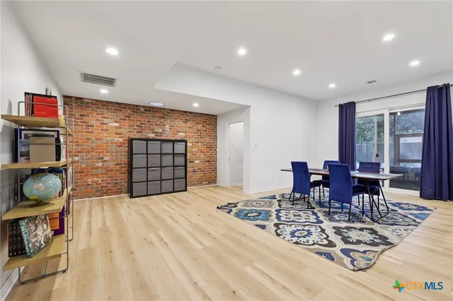 a view of a dining room with furniture and chandelier