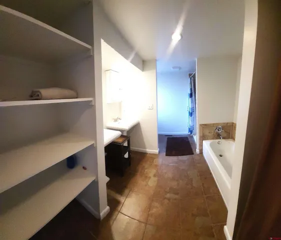 a bathroom with a bathtub and a sink