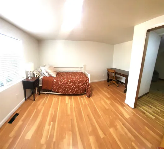 a bedroom with a bed and a dresser