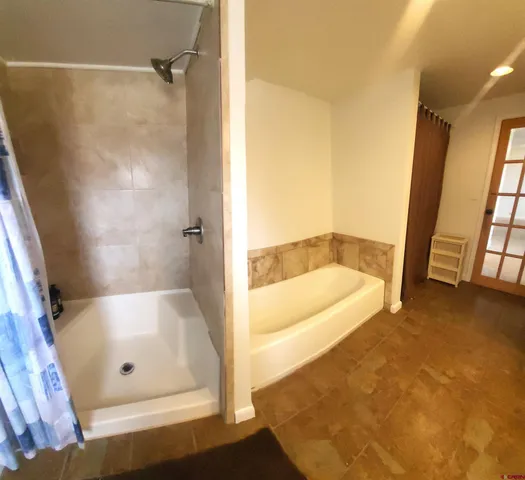 a bathroom with a tub and a shower