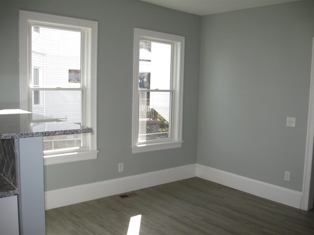 12 Alderman Street Springfield, MA 01108 - Photo 11 of 27 a view of an empty room with wooden floor and a window