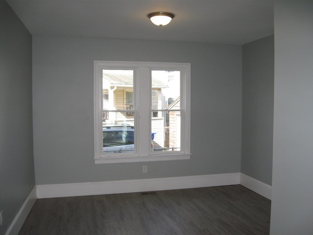 12 Alderman Street Springfield, MA 01108 - Photo 13 of 27 an empty room with wooden floor and windows