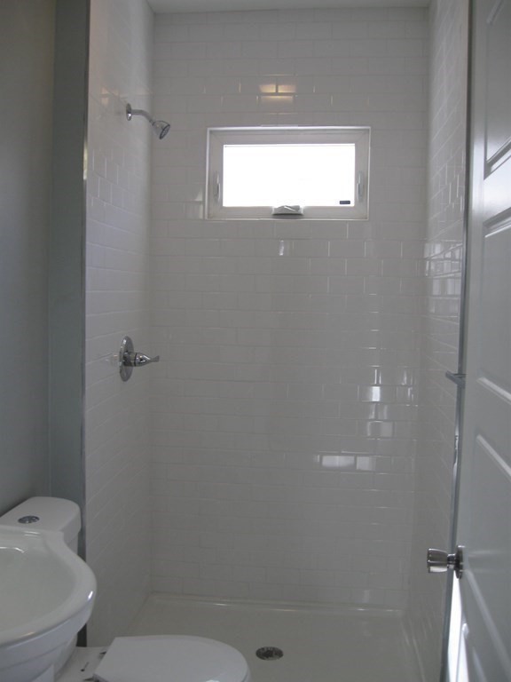 12 Alderman Street Springfield, MA 01108 - Photo 14 of 27 a bathroom with a toilet and a shower