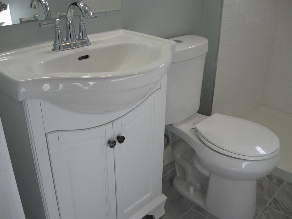 12 Alderman Street Springfield, MA 01108 - Photo 15 of 27 a bathroom with a sink a toilet and shower