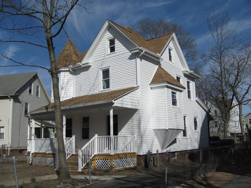 12 Alderman Street Springfield, MA 01108 - Photo 3 of 27 a view of a white house with large windows and a table and chairs