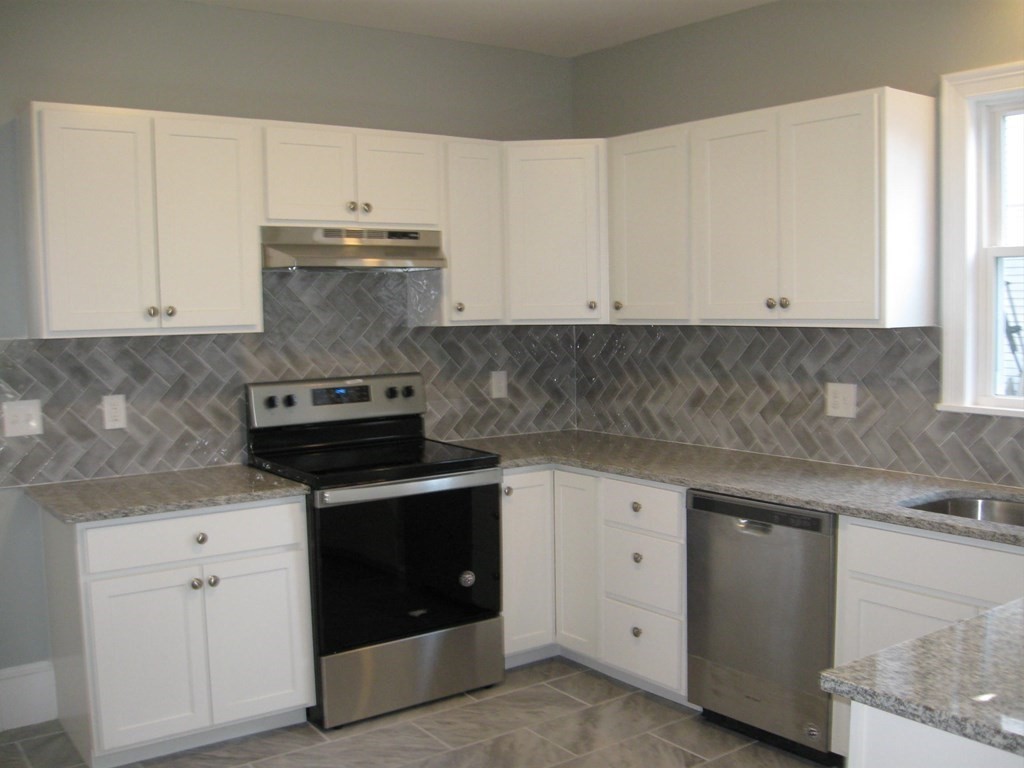 12 Alderman Street Springfield, MA 01108 - Photo 5 of 27 a kitchen with granite countertop white cabinets and white appliances