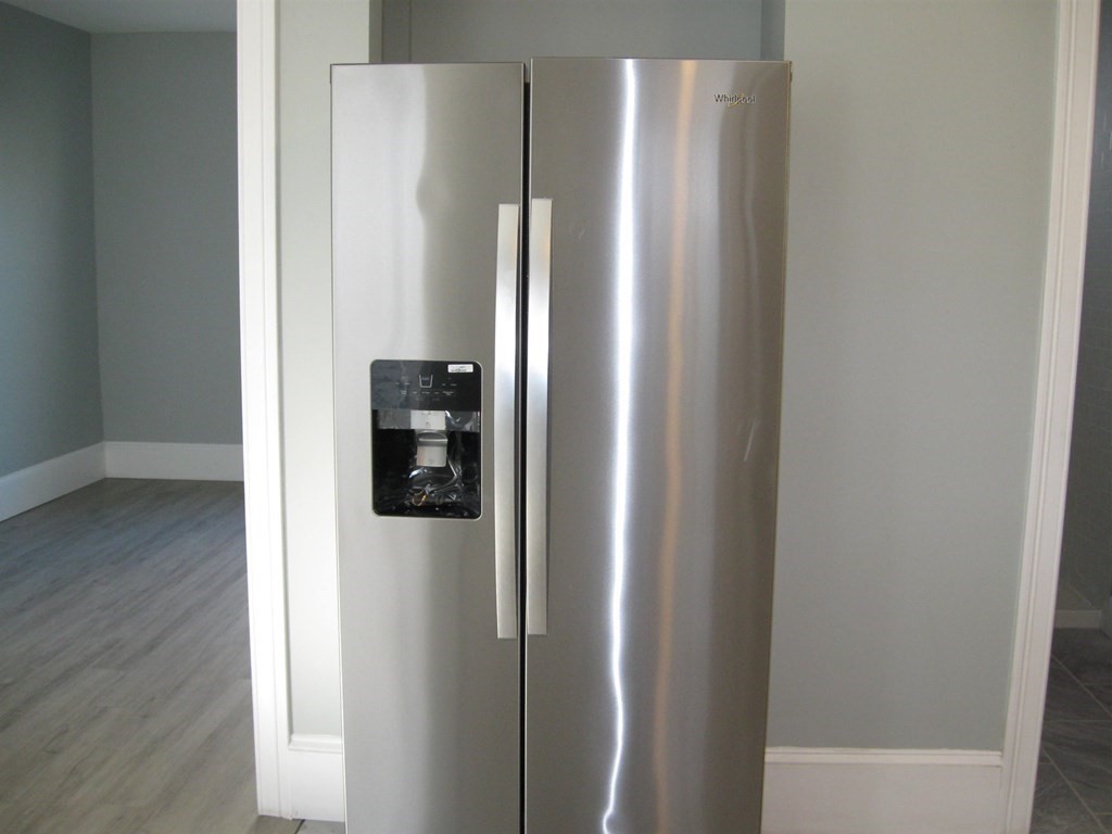 12 Alderman Street Springfield, MA 01108 - Photo 6 of 27 a view of a refrigerator in kitchen and wooden floor
