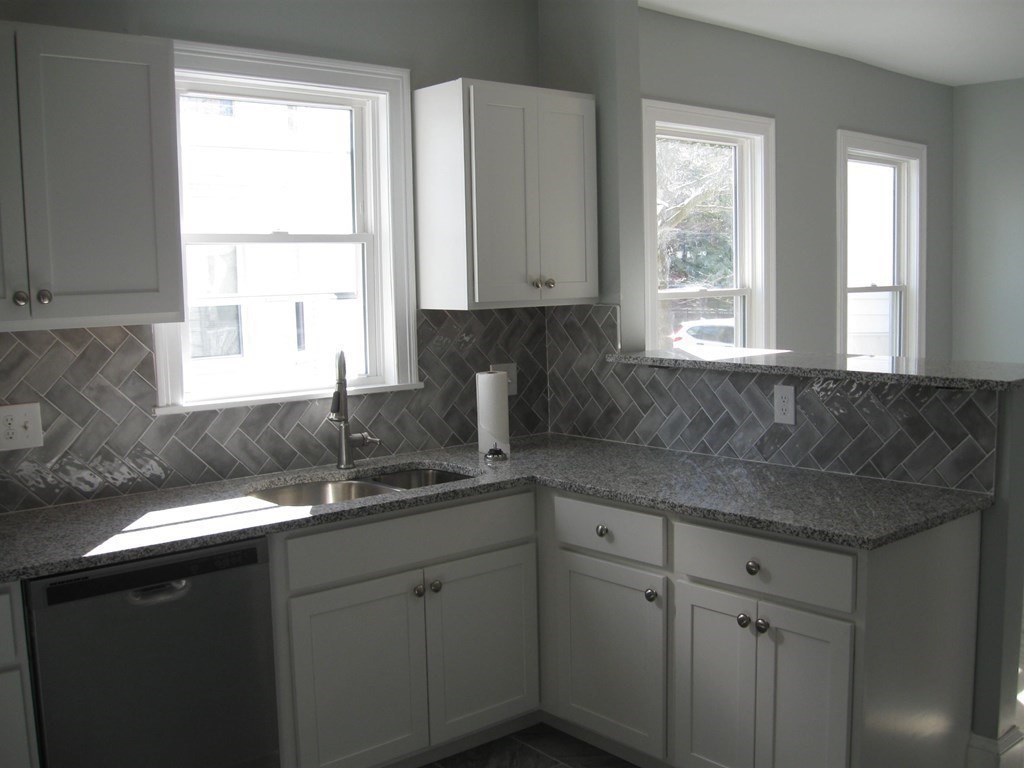 12 Alderman Street Springfield, MA 01108 - Photo 7 of 27 a kitchen with a sink a window and cabinets