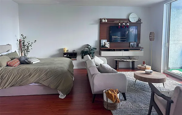 a living room with furniture dining table and a flat screen tv
