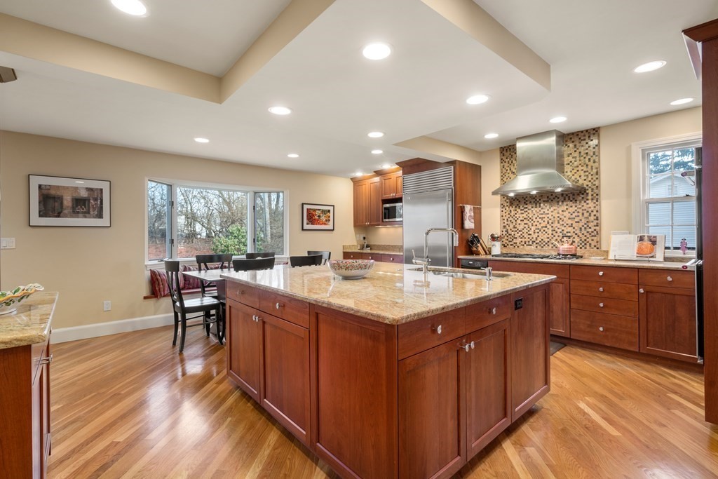 30 Terrace Drive Worcester, MA 01609 - Photo 3 of 39 a kitchen with a stove a sink a dining table and chairs