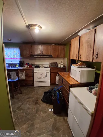 a kitchen with a stove a refrigerator and a sink