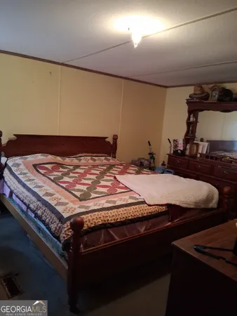 a bed sitting in a room next to a window